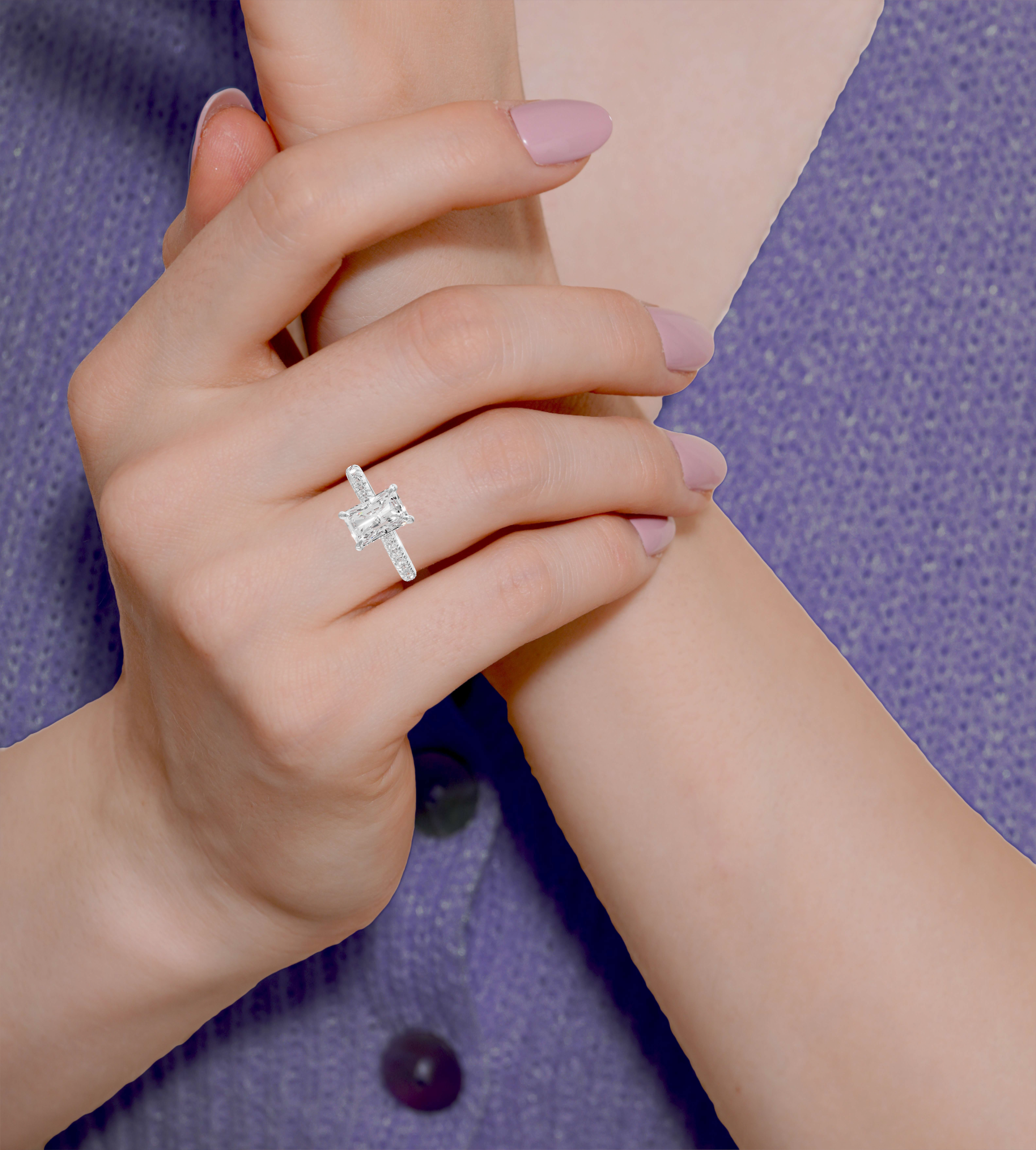 Radiant cut engagement ring with hidden halo and side stones in 14k white gold, featuring a 3.00 ct center stone.